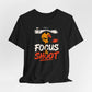 Black Focus & Shoot t-shirt with grunge camera design and orange urban street art aesthetic
