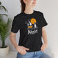 Black Adventure t-shirt with hand-drawn sailboat lighthouse and golden sun nautical design